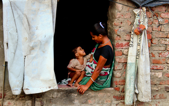 woman and child sitting in a window